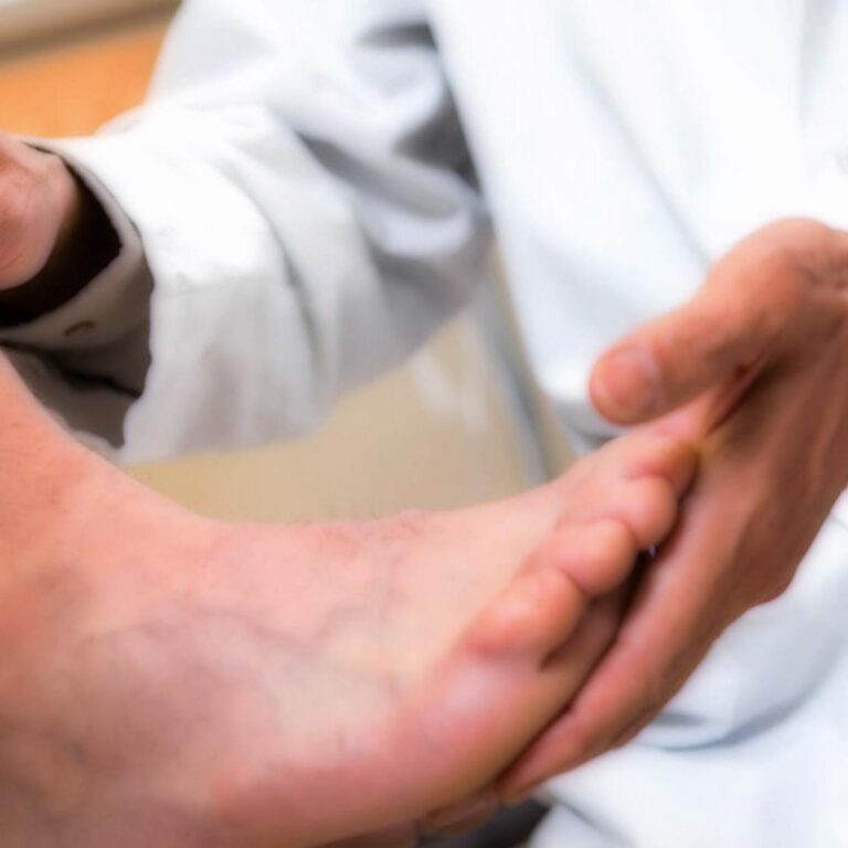 Doctor in a white coat examining a patient's bare foot