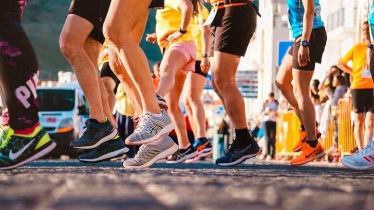 Runners' legs and trainers mid-stride at the start of a road race