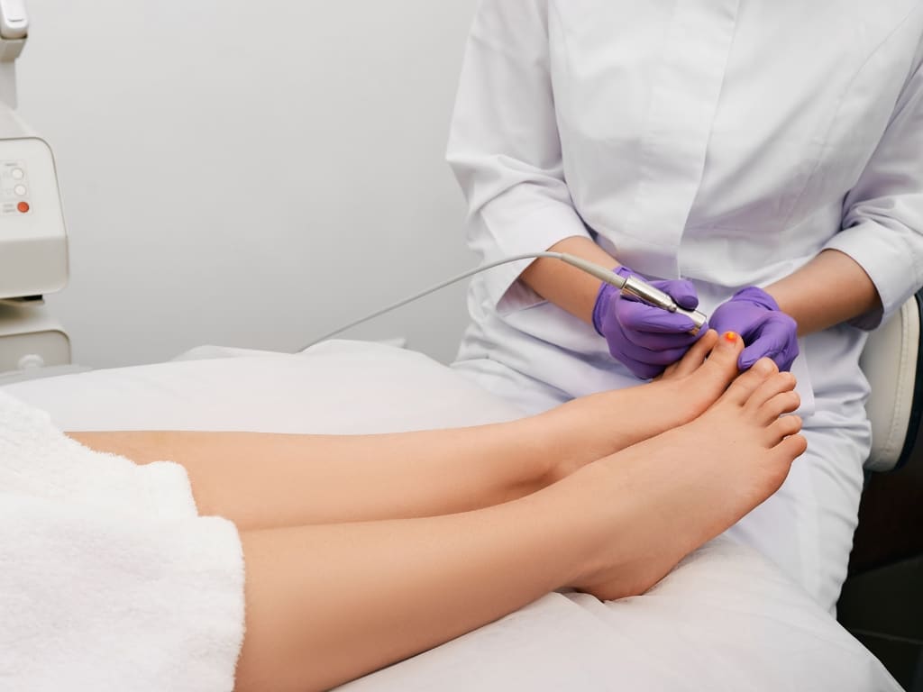 A close-up of a foot receiving laser therapy, highlighting the non-invasive technique used in modern podiatric care.