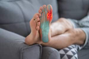 Sole of a foot with the ball of the foot highlighted in red, indicating metatarsalgia pain