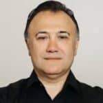 Dr. Emmanuel Fuzaylov in a black shirt with team members either side